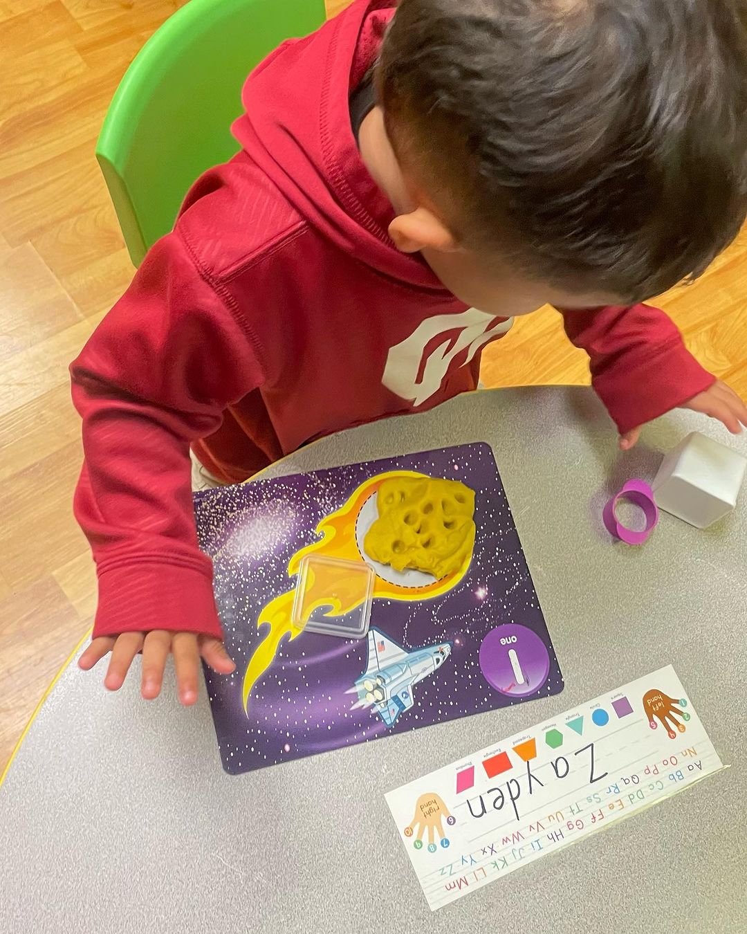 a young boy playing with a space themed activity